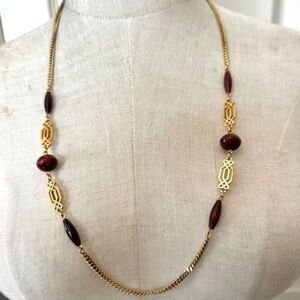 Gold tone and brown/red long beaded necklace
